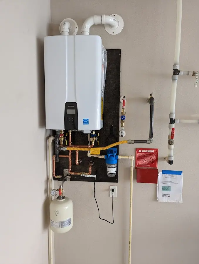 Professional plumber installing copper piping in a Fox Crossing home